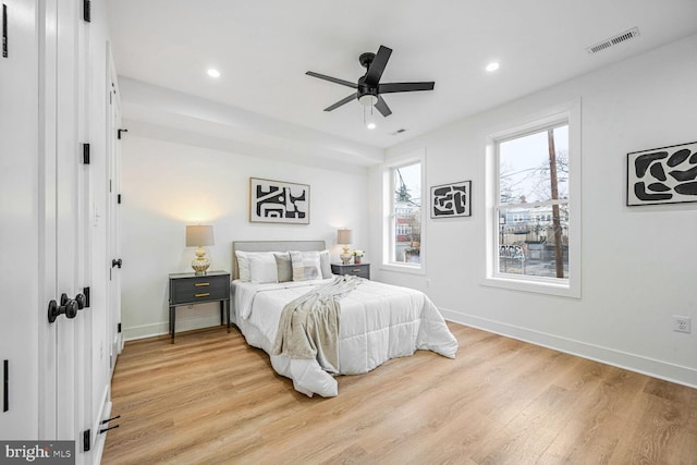 bedroom featuring light wood-style floors, recessed lighting, baseboards, and a ceiling fan
