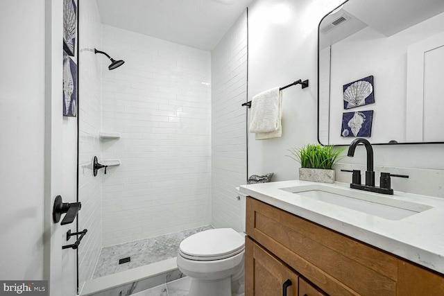 full bathroom with toilet, vanity, a shower stall, and marble finish floors