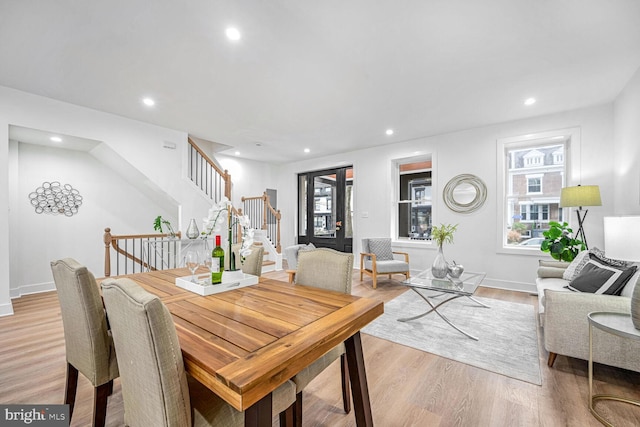 dining space featuring stairs, light wood finished floors, recessed lighting, plenty of natural light, and baseboards