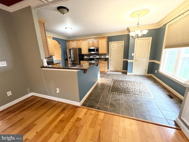 126 Greenway St, Fredericksburg, VA 22405 - kitchen with appliances with stainless steel finishes, baseboards, a chandelier, arched walkways, and a peninsula