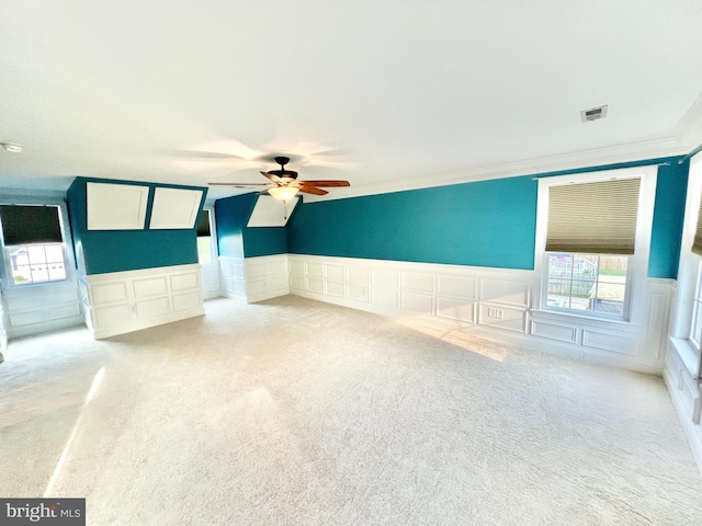 126 Greenway St, Fredericksburg, VA 22405 - empty room featuring light colored carpet, a decorative wall, a ceiling fan, wainscoting, and healthy amount of natural light