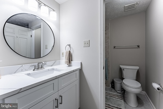 7414 Golden Horseshoe Ct, Springfield, VA 22153 - bathroom featuring vanity, a textured ceiling, and marble finish floors
