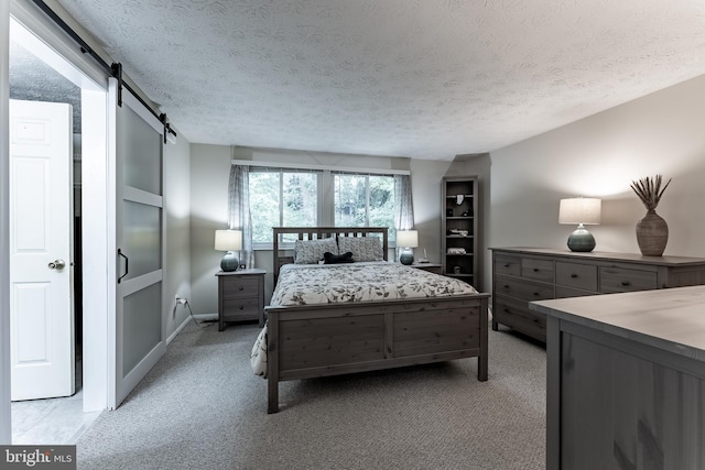 7414 Golden Horseshoe Ct, Springfield, VA 22153 - bedroom with a textured ceiling, light carpet, and a barn door