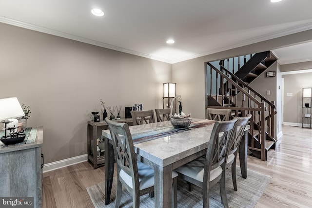 7414 Golden Horseshoe Ct, Springfield, VA 22153 - dining area featuring crown molding, light wood-style flooring, stairs, and recessed lighting