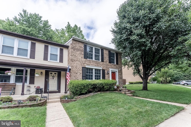 7414 Golden Horseshoe Ct, Springfield, VA 22153 - view of front of property with a front yard, a porch, and brick siding