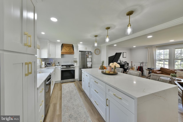 100 Shenandoah Rd, Cinnaminson, NJ 08077 - kitchen featuring appliances with stainless steel finishes, a sink, white cabinets, open floor plan, and backsplash