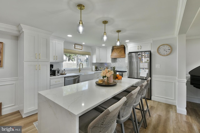 100 Shenandoah Rd, Cinnaminson, NJ 08077 - kitchen with stainless steel appliances, custom range hood, a decorative wall, white cabinets, and light wood-style floors