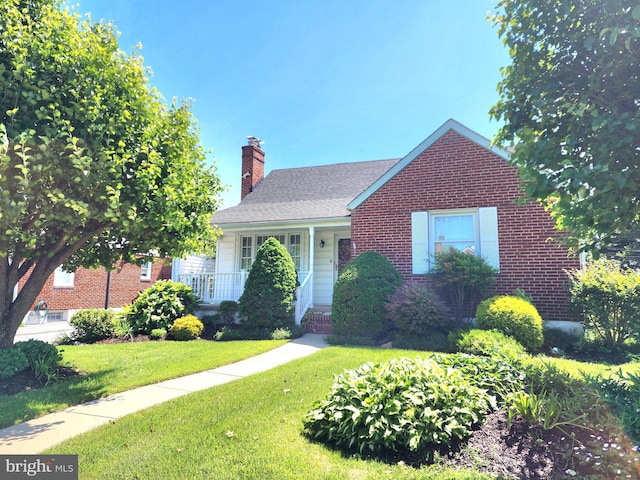 9109 Carlisle Ave, Baltimore, MD 21236 - view of front facade with brick siding, a chimney, a front yard, and a porch