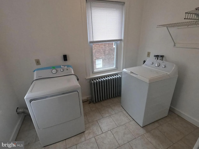 laundry area featuring radiator heating unit, independent washer and dryer, baseboards, and light tile patterned floors