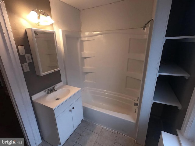 bathroom with tile patterned floors, shower / bathtub combination, and vanity