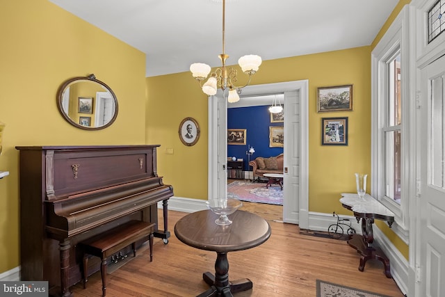 100 W Maple Ave, Merchantville, NJ 08109 - living area featuring baseboards, hardwood / wood-style flooring, and a chandelier