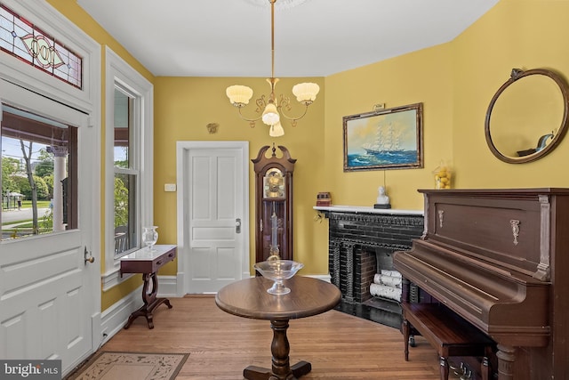 100 W Maple Ave, Merchantville, NJ 08109 - entrance foyer featuring a chandelier, wood finished floors, a fireplace, and baseboards
