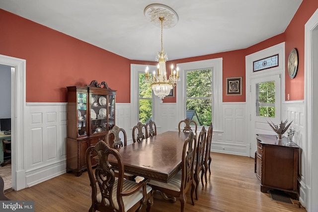 100 W Maple Ave, Merchantville, NJ 08109 - dining space featuring wainscoting, a chandelier, light wood-style floors, and a decorative wall