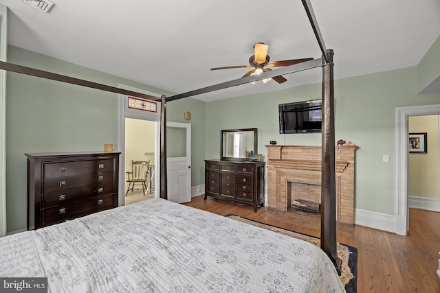 100 W Maple Ave, Merchantville, NJ 08109 - bedroom with baseboards, wood finished floors, and a fireplace