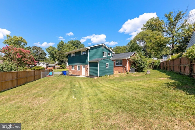 back of property featuring brick siding and central AC