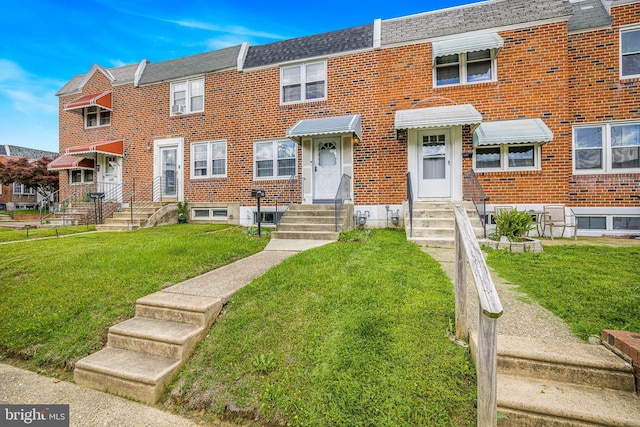 1243 Maple Ave, Wilmington, DE 19805 - view of property featuring entry steps, brick siding, and a front lawn