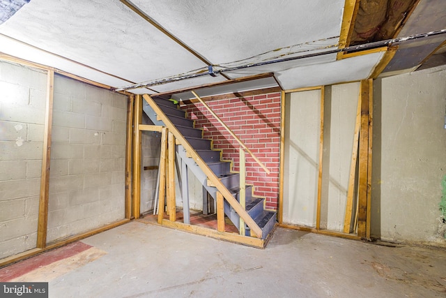 1243 Maple Ave, Wilmington, DE 19805 - unfinished below grade area with stairway and concrete block wall