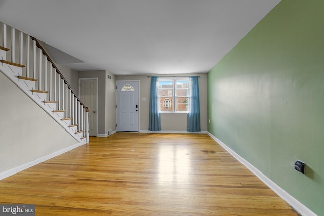 1243 Maple Ave, Wilmington, DE 19805 - foyer entrance with light wood-type flooring, stairway, and baseboards