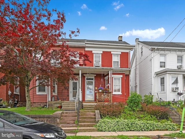 328 W 2nd St, Birdsboro, PA 19508 - townhome / multi-family property featuring a porch, brick siding, and a chimney