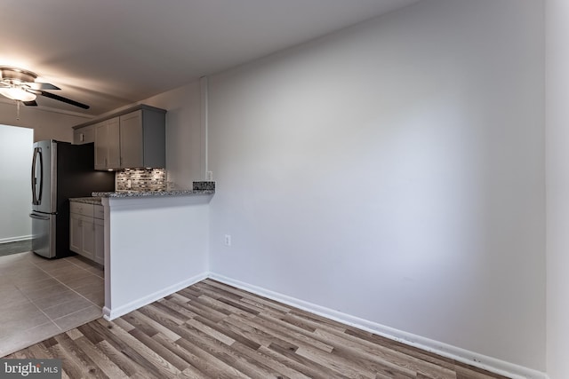2856 Dover Ln Unit 103, Falls Church, VA 22042 - kitchen featuring a ceiling fan, gray cabinetry, backsplash, wood finished floors, and light stone counters