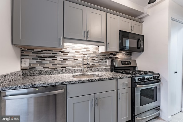 2856 Dover Ln Unit 103, Falls Church, VA 22042 - kitchen with appliances with stainless steel finishes, backsplash, and dark stone counters