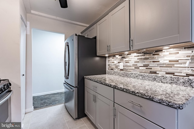 2856 Dover Ln Unit 103, Falls Church, VA 22042 - kitchen with stainless steel appliances, tasteful backsplash, light stone counters, and light tile patterned floors