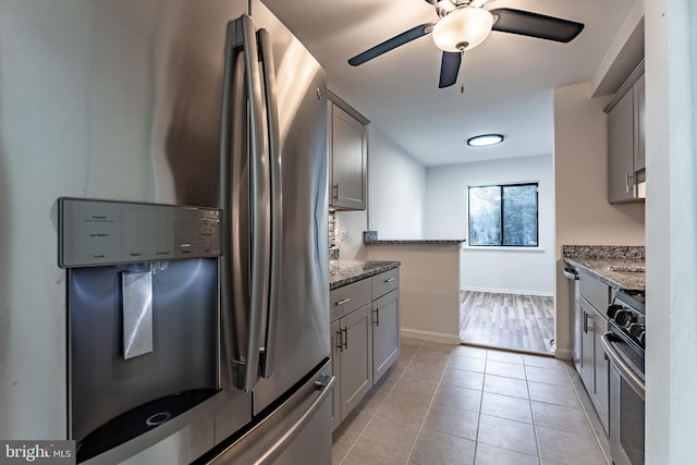 2856 Dover Ln Unit 103, Falls Church, VA 22042 - kitchen with appliances with stainless steel finishes, gray cabinetry, stone counters, and a ceiling fan