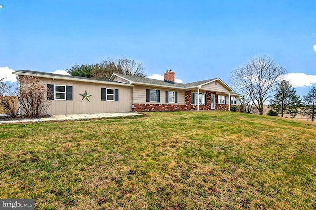 single story home with a chimney, brick siding, and a front yard