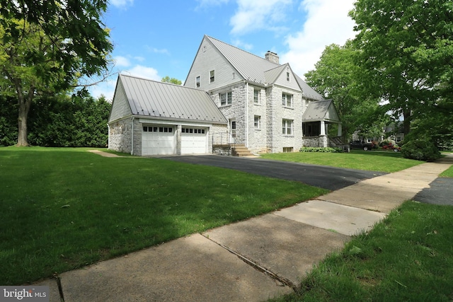 441-445 Ridge Ave, State College, PA 16803 - view of front facade featuring stone siding, a chimney, metal roof, a front lawn, and asphalt driveway