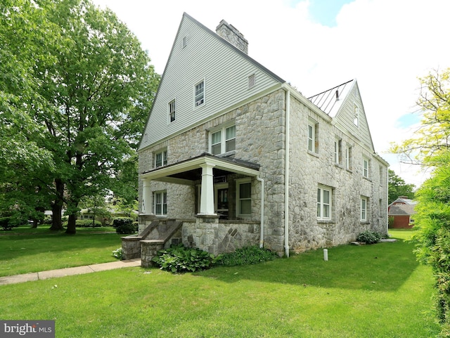 441-445 Ridge Ave, State College, PA 16803 - view of property exterior with stone siding, a lawn, a chimney, and a standing seam roof