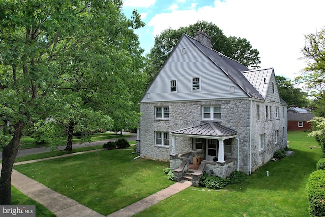 441-445 Ridge Ave, State College, PA 16803 - back of property with stone siding, a porch, a chimney, and a yard
