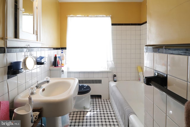 441-445 Ridge Ave, State College, PA 16803 - full bathroom with tile walls, radiator heating unit, plenty of natural light, toilet, and a bath