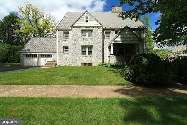 441-445 Ridge Ave, State College, PA 16803 - view of front of property featuring stone siding, driveway, a chimney, a standing seam roof, and an attached garage