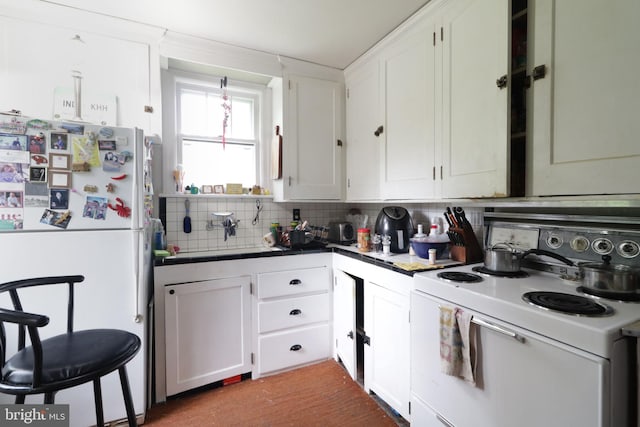 441-445 Ridge Ave, State College, PA 16803 - kitchen featuring white appliances, tasteful backsplash, tile counters, and white cabinets