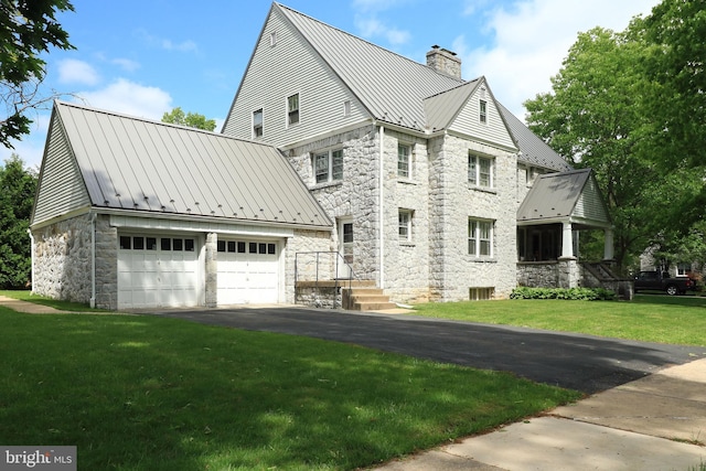 441-445 Ridge Ave, State College, PA 16803 - view of side of property with a standing seam roof, a chimney, stone siding, metal roof, and an outdoor structure