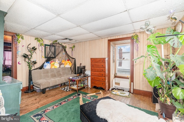 135 Lucknow Rd, Harrisburg, PA 17110 - living area featuring a paneled ceiling, hardwood / wood-style floors, wooden walls, and baseboards