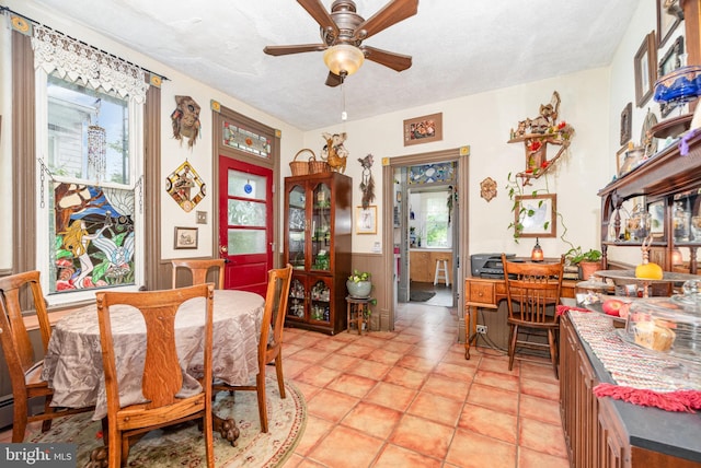 135 Lucknow Rd, Harrisburg, PA 17110 - dining space with a wainscoted wall, a ceiling fan, and a textured ceiling