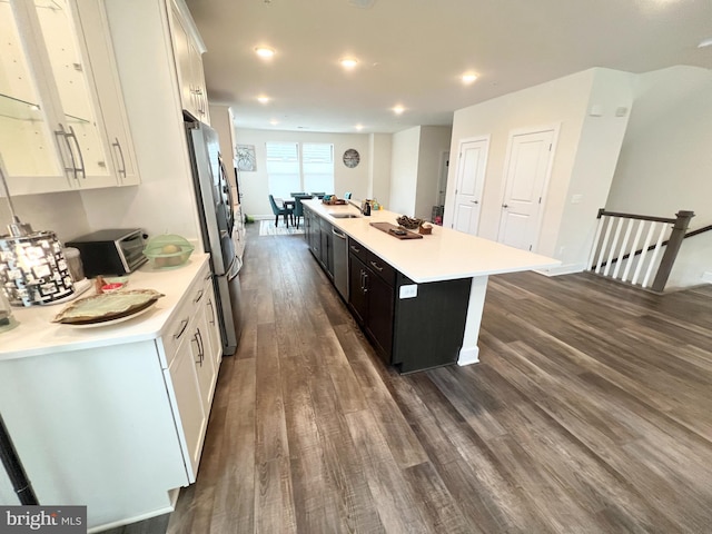 10407 Ratcliffe Trl, Manassas, VA 20110 - kitchen with a sink, appliances with stainless steel finishes, dark wood finished floors, light countertops, and white cabinets