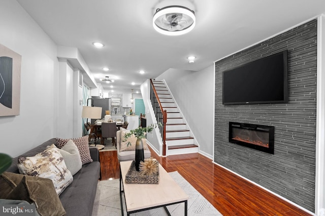 510 N Glover St, Baltimore, MD 21205 - living room featuring wood finished floors, stairway, a fireplace, recessed lighting, and baseboards
