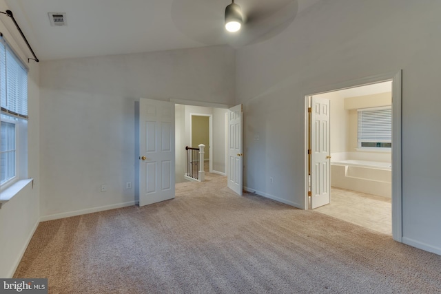 1451 Apple, Saint Leonard, MD 20685 - unfurnished bedroom with carpet flooring, multiple windows, high vaulted ceiling, and baseboards