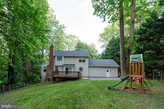 1451 Apple, Saint Leonard, MD 20685 - back of house featuring a chimney, a lawn, a deck, a playground, and central AC
