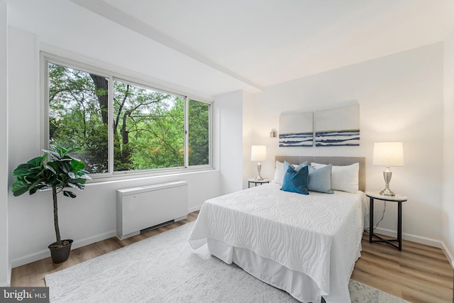 4000 Tunlaw Rd NW Unit 603, Washington, DC 20007 - bedroom featuring wood finished floors, baseboards, and radiator heating unit