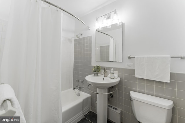 4000 Tunlaw Rd NW Unit 603, Washington, DC 20007 - bathroom featuring toilet, tile walls, shower / tub combo, and a wainscoted wall