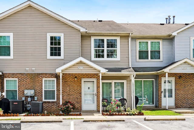 205 Highland Blvd, New Castle, DE 19720 - townhome / multi-family property with central AC, uncovered parking, brick siding, and a shingled roof