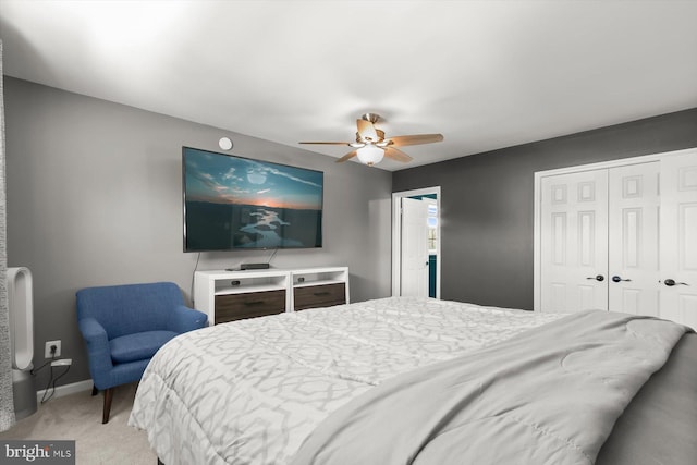 bedroom featuring a closet, light carpet, a ceiling fan, and baseboards