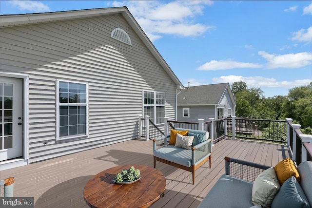 wooden terrace with outdoor lounge area
