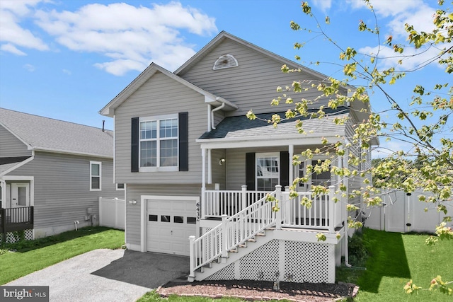 view of front of house with a porch, an attached garage, and driveway