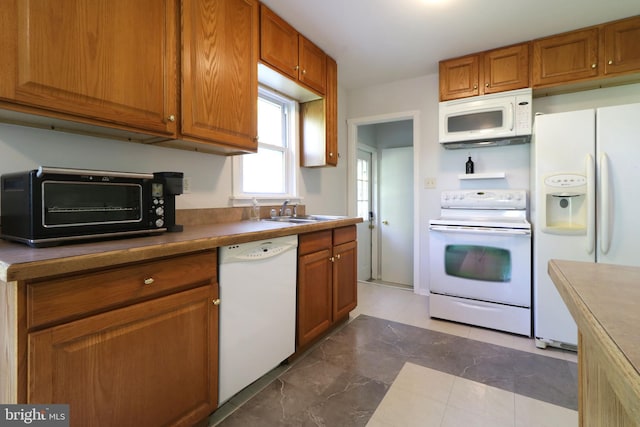 250 E Main St, Millheim, PA 16854 - kitchen with white appliances, a sink, and brown cabinetry