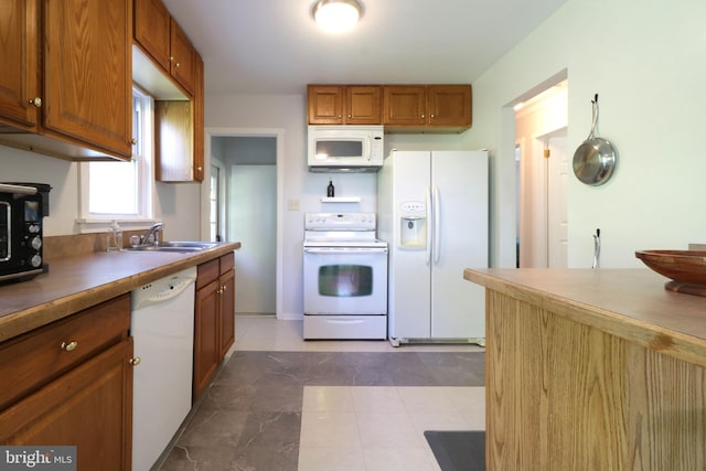 250 E Main St, Millheim, PA 16854 - kitchen with white appliances, a sink, and brown cabinetry
