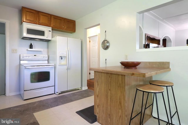 250 E Main St, Millheim, PA 16854 - kitchen featuring white appliances, brown cabinetry, a kitchen bar, a peninsula, and ornamental molding